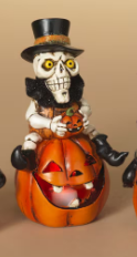 LIGHTED HALLOWEEN FIGURINE SITTING ON PUMPKIN