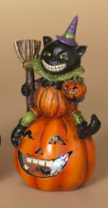 LIGHTED HALLOWEEN FIGURINE SITTING ON PUMPKIN