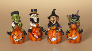 LIGHTED HALLOWEEN FIGURINE SITTING ON PUMPKIN