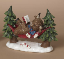 Load image into Gallery viewer, HOLIDAY HIGHLAND COW IN HAMMOCK FIGURINE
