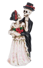 Load image into Gallery viewer, Skeleton couple figurine with floral accessories on a white background
